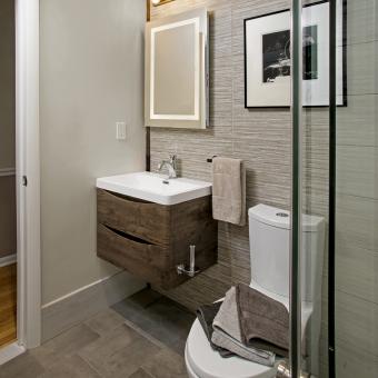 Wall Hung Vanity and Back Lit Mirror in a Modern Bath
